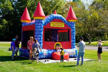 Children playing at an inflatable bounce house at Rec Jam.